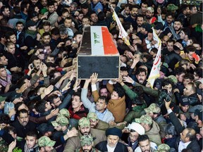 Mourners carry the coffin of slain Iraqi paramilitary chief Abu Mahdi al-Muhandis towards the Imam Ali Shrine in the shrine city of Najaf in central Iraq during a funeral procession on January 4, 2020. - Thousands of Iraqis chanted "Death to America" today as they mourned the deaths of  al-Muhandis and Iranian military commander Qasem Soleimani who were killed in a US drone attack that sparked fears of a regional proxy war between Washington and Tehran.