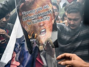 Protesters in Delhi burn a poster representing U.S. President Donald Trump after the Americans killed Iranian commander Qassem Soleimani in Iraq.