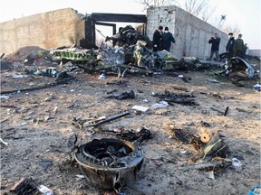 People and rescue teams are pictured amid the wreckage after a Ukrainian plane carrying 176 passengers crashed near Imam Khomeini airport in the Iranian capital Tehran early in the morning on January 8, 2020, killing everyone on board. - The Boeing 737 had left Tehran's international airport bound for Kiev, semi-official news agency ISNA said, adding that 10 ambulances were sent to the crash site.