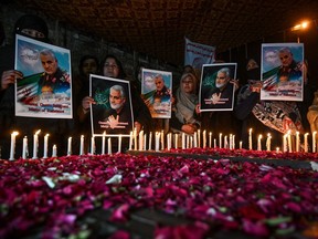 Shiite Muslims in Pakistan hold pictures of slain Iranian Gen. Qassem Soleimani