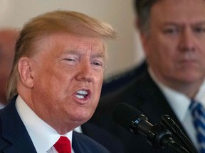 US Secretary of State Mike Pompeo, right, listens as U.S. President Donald Trump speaks about the situation with Iran in the Grand Foyer of the White House in Washington, D.C., Jan. 8, 2020.