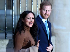 (FILES) In this file photo taken on January 07, 2020 Britain's Prince Harry, Duke of Sussex and Meghan, Duchess of Sussex react as they leave after her visit to Canada House in thanks for the warm Canadian hospitality and support they received during their recent stay in Canada, in London. - Britain's Prince Harry, Meghan are to step back as 'senior' royals, Buckingham Palace announced on January 8, 2010.