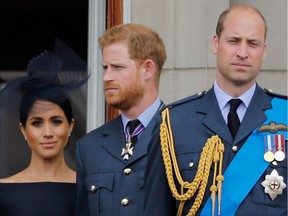 (FILES) In this file photo taken on July 10, 2018 (L-R) Britain's Meghan, Duchess of Sussex, Britain's Prince Harry, Duke of Sussex, and Britain's Prince William, Duke of Cambridge, stand on the balcony of Buckingham Palace.