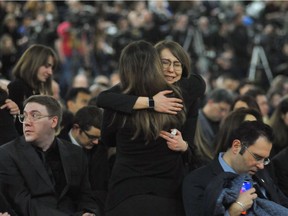 Mourners in Edmonton console each other at a memorial service for the victims of Ukrainian Airlines flight 752.