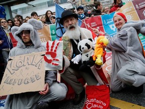 Protesters dressed as koalas demonstrate during a climate strike against governmental inaction towards climate breakdown and environmental pollution in Lausanne, on January 17, 2020. - Swedish climate campaigner Greta Thunberg joined several thousand protesters in the streets of the Swiss city of Lausanne, days before the start of the Davos summit