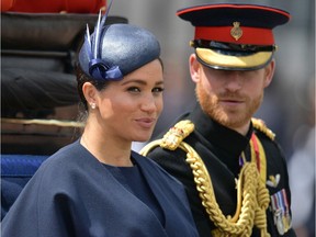 (FILES) In this file photo taken on June 08, 2019 Britain's Meghan, Duchess of Sussex (L) and Britain's Prince Harry, Duke of Sussex (R) return to Buckingham Palace after the Queen's Birthday Parade, 'Trooping the Colour', in London. - Britain's Prince Harry and his wife Meghan will give up their titles and stop receiving public funds following their decision to give up front-line royal duties, Buckingham Palace said on January 18, 2020.