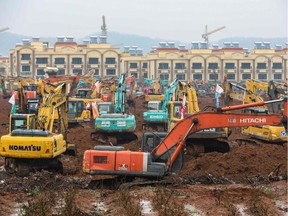 This photo on January 24, 2020 shows excavators at the construction site of a new hospital being built to treat patients from a deadly virus outbreak in Wuhan in China's central Hubei province. - China is rushing to build a new hospital in a staggering 10 days to treat patients at the epicentre of a deadly virus outbreak that has stricken hundreds of people, state media reported on January 24. (Photo by STR / AFP) / China OUT