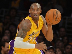 (FILES) In this file photo taken on January 02, 2015 Kobe Bryant of the Los Angeles Lakers drives against the Memphis Grizzlies during their NBA game 33 at the Staples Center in Los Angeles.