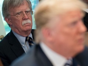 (FILES) In this file photo taken on May 9, 2018, US President Donald Trump speaks alongside National Security Adviser John Bolton (L) during a Cabinet Meeting.