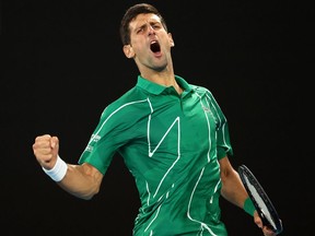 Serbia's Novak Djokovic reacts after winning his first set against Canada's Milos Raonic during their men's singles quarter-final match on Tuesday.