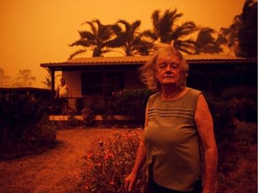 Nancy Allen and Brian Allen stand outside the house as high winds push smoke and ash from the Currowan Fire towards Nowra, New South Wales, Australia January 4, 2020.