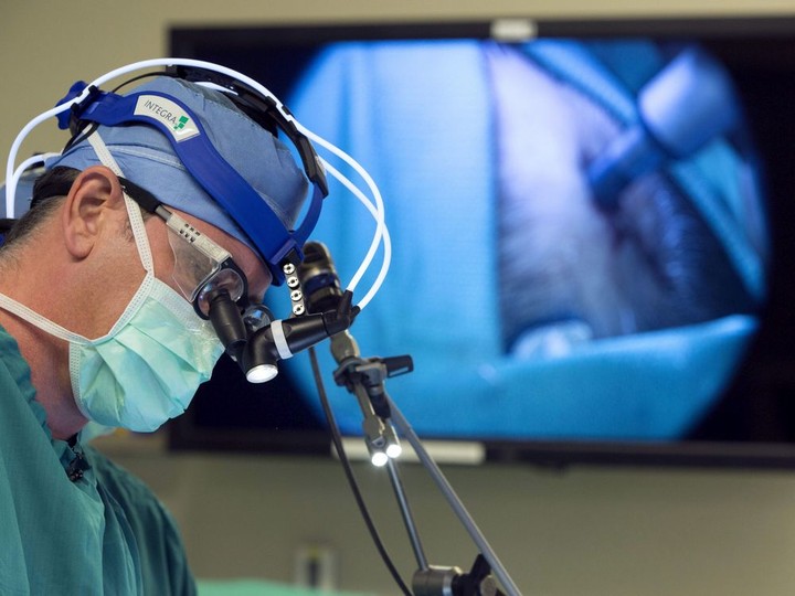  In this Oct. 28, 2014 photo, neurosurgeon Dr. John Sampson places a catheter into a glioblastoma patient at Duke in Durham, N.C. The risk of cancer increases with age. SHAWN ROCCO / THE ASSOCIATED PRESS