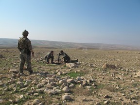 This file photo shows a member of the Canadian Special Operations Forces Command (CANSOFCOM) providing Kurds with training in Iraq. (CANSOFCOM photo)