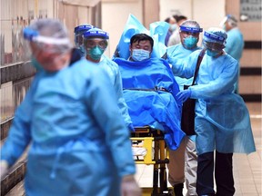 Medical staff transfer a patient of a highly suspected case of a new coronavirus at the Queen Elizabeth Hospital in Hong Kong, China January 22, 2020. Picture taken January 22, 2020.