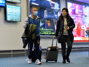 A traveller wears a mask, after arriving on a direct flight from China, as Canada's Public Health Agency added a screening question for visitors and began displaying messages in several airports urging travellers to report flu-like symptoms in efforts to prevent any introduction of coronavirus, at Vancouver International Airport in Richmond, British Columbia, Canada January 24, 2020.