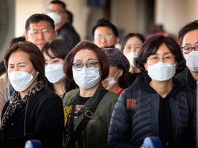 Passengers wear face masks to protect against the spread of the coronavirus as they arrive at Los Angeles International Airport, California, on Jan. 29, 2020.