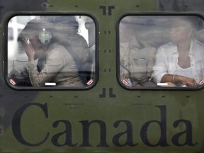 Canadian Governor General Michaelle Jean, left, breaks down after boarding the helicopter following a tour of Jacmel, Haiti, Tuesday March 9, 2010. Jean is in her home country for her first visit since the devastating earthquake. Jean's five-year term concludes this week with viceregal transition ceremonies.THE CANADIAN PRESS/Paul Chiasson