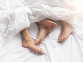 A couple in bed. A study has found that a healthy sex life could delay menopause.