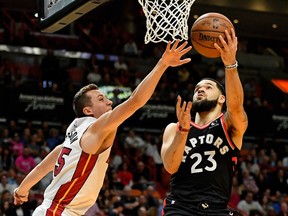 Raptors guard Fred VanVleet shoots around Heat forward Duncan Robinson during the first half of Thursday night's game in Miami.