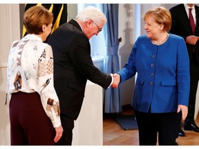 German President Frank-Walter Steinmeier and his wife welcome Chancellor Angela Merkel at a New Year's reception in Berlin. Soon, Merkel will be gone.