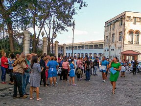 Workers leave the building of the Lonja del Comercio (Commerce Market) building after a quake in Havana on January 28, 2020. - A major 7.7 magnitude quake struck Tuesday in the Caribbean northwest of Jamaica, the US Geological Survey reported, raising the risk of tsunami waves in the region.