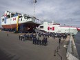 Shipbuilders, military personnel and others  attend the naming ceremony for Canada's lead Arctic and Offshore Patrol Ship, the future HMCS Harry DeWolf, at Halifax Shipyard in 2018.