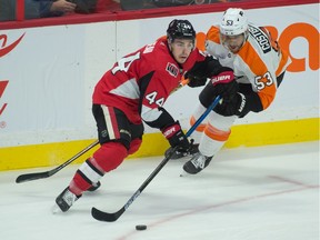 Dec 21, 2019; Ottawa, Ontario, CAN; 
Ottawa Senators center Jean-Gabriel Pageau shoots the puck with Philadelphia Flyers center Shayne Gostisbehere in pursuit during the third period at the Canadian Tire Centre on Dec. 21, 2019.