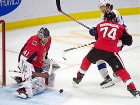 Ottawa Senators goalie Craig Anderson makes a save in front of Tampa Bay Lightning centre Brayden Point and defenceman Mark Borowiecki on Jan. 4, 2020