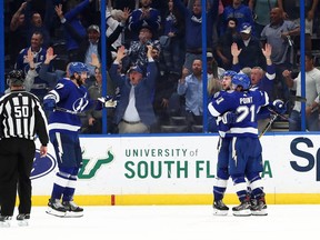 ampa Bay Lightning center Anthony Cirelli (71) is congratulated by Tampa Bay Lightning center Brayden Point (21) and teammates as he scores the game winning goal against the Ottawa Senators  during overtime at Amalie Arena.