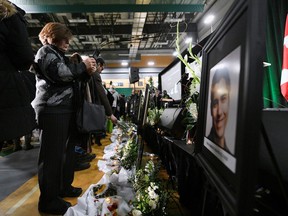 Flowers and photos of the victims set up at a memorial service on Saturday at the University of Alberta in Edmonton for the victims of a Ukrainian passenger plane that crashed in Iran.