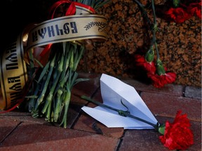 Flowers and a paper plane are placed outside the Iranian Embassy to commemorate the victims of the Ukraine International Airlines flight PS752 plane crash, in Kiev, Ukraine January 8, 2020.