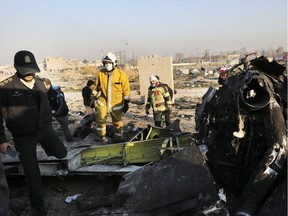 Debris is seen from an Ukrainian plane which crashed as authorities work at the scene in Shahedshahr, southwest of the capital Tehran, Iran, Wednesday, Jan. 8, 2020. A Ukrainian airplane carrying 176 people crashed on Wednesday shortly after takeoff from Tehran's main airport, killing all onboard.