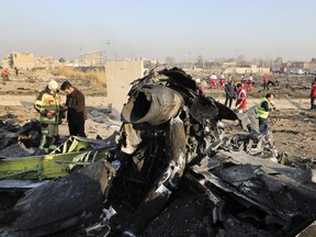 Debris is seen from an Ukrainian plane which crashed as authorities work at the scene in Shahedshahr, southwest of the capital Tehran, Iran, Wednesday, Jan. 8, 2020.