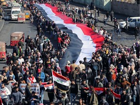 University students carry an Iraqi flag, during ongoing anti-government protests in Baghdad, Iraq January 26, 2020. REUTERS/Thaier al-Sudani