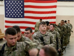 U.S Army paratroopers assigned to 1st Brigade Combat Team, 82nd Airborne Division prepare to board an aircraft bound for the U.S. Central Command area of operations from Fort Bragg, North Carolina, U.S. January 4, 2020.