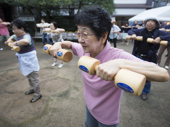  A woman exercises with wooden dumbbells during an event marking Respect for the Aged Day at a temple in the Sugamo district of Tokyo, Japan, on Monday, Sept. 19, 2016. The proportion of Japan’s aged has been rising steadily for decades, with U.S. Census Bureau data showing that last year more than one in four Japanese were over 65. TOMOHIRO OHSUMI / BLOOMBERG
