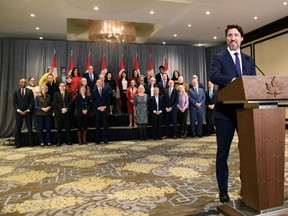 Prime Minister Justin Trudeau stands in front of his cabinet as he speaks to reporters during the final day of the Liberal cabinet retreat in Winnipeg, Jan. 21, 2020.