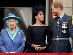 Queen Elizabeth II, Meghan the Duchess of Sussex and Prince Harry at Buckingham Palace on July 10, 2018.