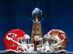 Helmets for the Kansas City Chiefs and San Francisco 49ers are placed in front of the Vince Lombardi Trophy during a press conference before Super Bowl LIV.