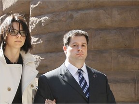 Files: Constable James Forcillo, escorted by his wife Irini, leaves  Old City Hall in downtown Toronto  on April 22, 2014 after a preliminary hearing into the shooting death of  Sammy Yatim aboard a TTC streetcar