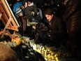 Prime Minister Justin Trudeau places a candle on Parliament Hill during a vigil for the victims who were killed in a plane crash in Iran on Jan. 9, 2020, in Ottawa.