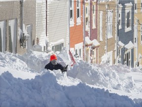 A resident digs out his walkway in St. John's on Saturday, Jan. 18, 2020. The state of emergency ordered by the City of St. John's is still in place, leaving businesses closed and vehicles off the roads in the aftermath of the major winter storm that hit the Newfoundland and Labrador capital.
