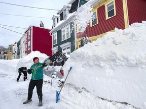 Residents dig out their car in St. John's on Sunday, Jan. 19, 2020. The state of emergency ordered by the City of St. John's continues, leaving businesses closed and vehicles off the roads in the aftermath of the major winter storm that hit the Newfoundland and Labrador capital.