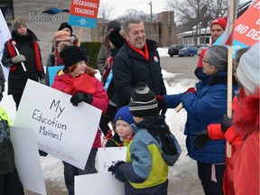 Elementary Teachers' Federation of Ontario (ETFO) president Sam Hammond greets striking teachers and their supporters Friday at a picket line set up in front of Bruce-Grey-Owen Sound Progressive Conservative MPP Bill Walker's constituency office in Owen Sound.