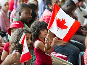 Children wave the Canadian flag at a citizenship ceremony in Gatineau on July 1, 2014. Lester Pearson felt the need for a distinctly Canadian symbol.