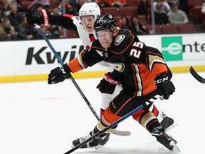 Brady Tkachuk #7 of the Ottawa Senators trips Ondrej Kase #25 of the Anaheim Ducks during the first period of a game at Honda Center on January 9, 2019 in Anaheim, California.