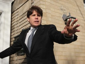 Former Illinois Governor Rod Blagojevich waves to supporters outside his home after returning from his sentencing hearing December 7, 2011 in Chicago, Illinois.