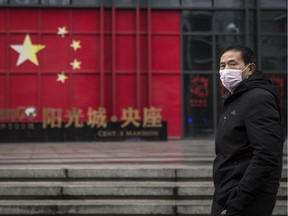 WUHAN, CHINA - FEBRUARY 10:  A man wears a protective mask as walk in street on February 10, 2020 in Wuhan, China.