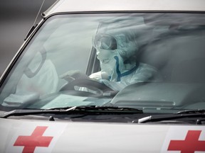 An emergency worker in protective clothing drives an ambulance carrying a person diagnosed with COVID-19 from the Diamond Princess cruise ship as it sits at Daikoku Pier where it is being resupplied and newly diagnosed COVID-19 cases taken for treatment as it remains in quarantine after a number of the 3,700 people on board were diagnosed with coronavirus, on February 13, 2020 in Yokohama, Japan. At least 219 passengers and crew onboard the Diamond Princess cruise ship have tested positive for COVID-19 making it the biggest centre of the virus outside China. Japan has also so far diagnosed 28 other people with the illness, some of whom are evacuees from Wuhan, and has announced measures to ban entry to foreign travellers from Zhejiang alongside an existing ban on non-Japanese nationals coming from Hubei.