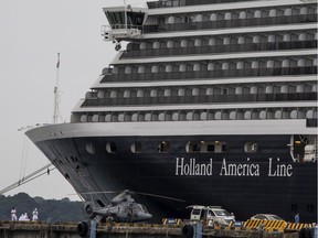 Health officials stand guard outside the MS Westerdam cruise ship in Sihanoukville, Cambodia on February 17, 2020.